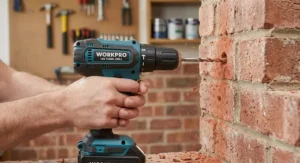 An affordable budget combi drill using hammer mode to drill a hole into a red brick masonry wall