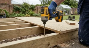 Illustration of an 18V compact impact driver driving a heavy-duty screw into timber decking joists