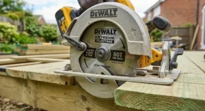 Close-up of a carbide-tipped saw blade on a cordless circular saw designed for clean decking cuts.