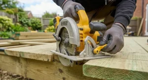 Setting the blade cutting depth on an 18V cordless circular saw to match timber decking board thickness.