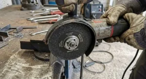 Close-up of a 125mm angle grinder disc guard and metal cutting wheel