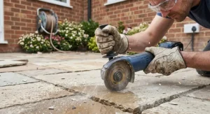 Compact cordless angle grinder under £100 being used for patio stone trimming